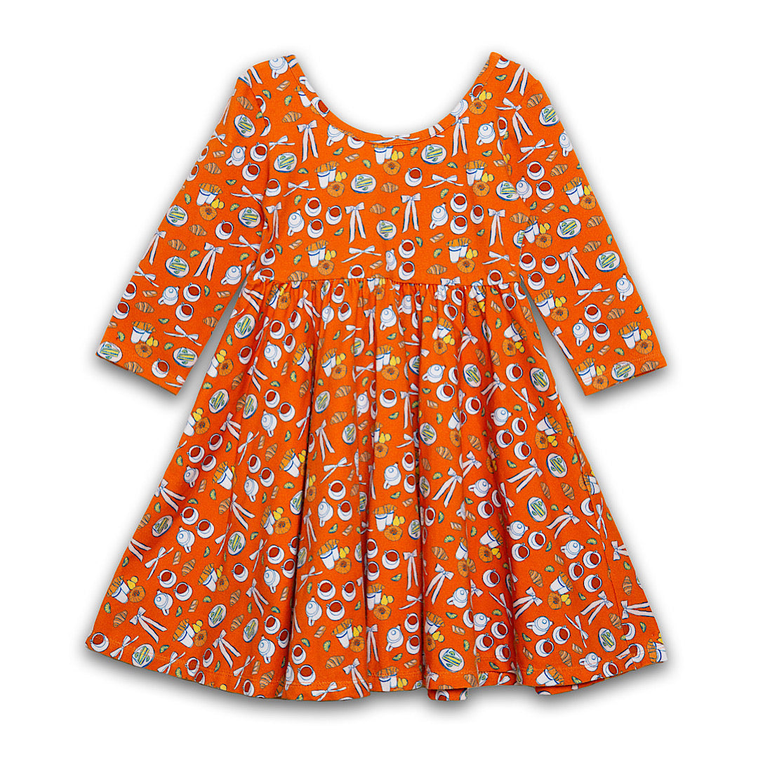 Girls twirly dress in orange with coffee and croissants