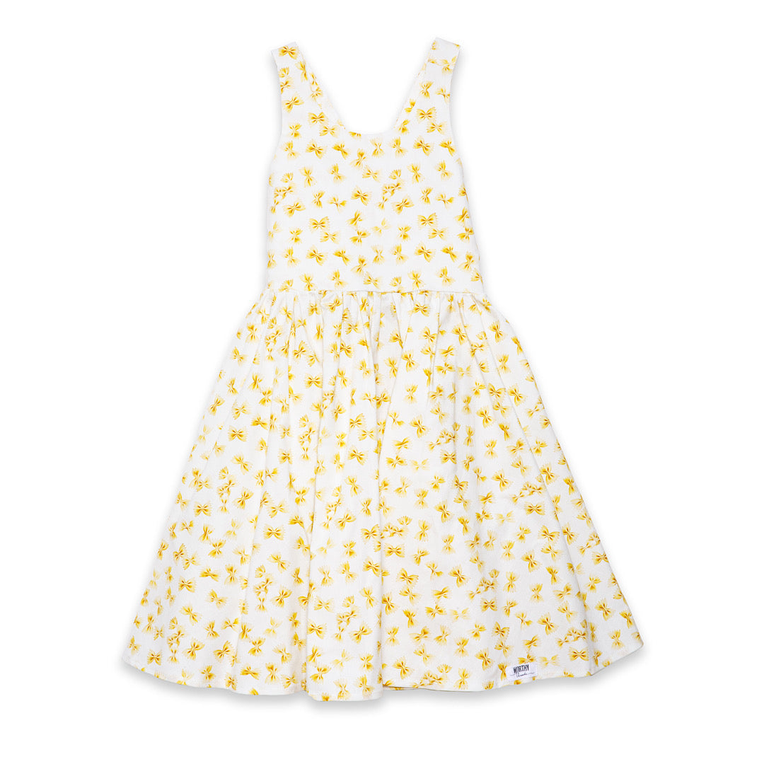 Girls summer dress featuring bow tie pasta, cross back straps and pockets