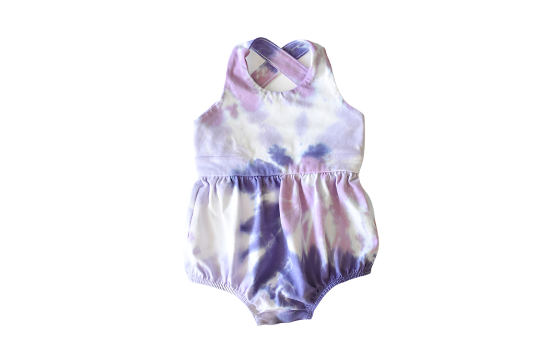 Baby bubble romper in purple tie dye: cross back design